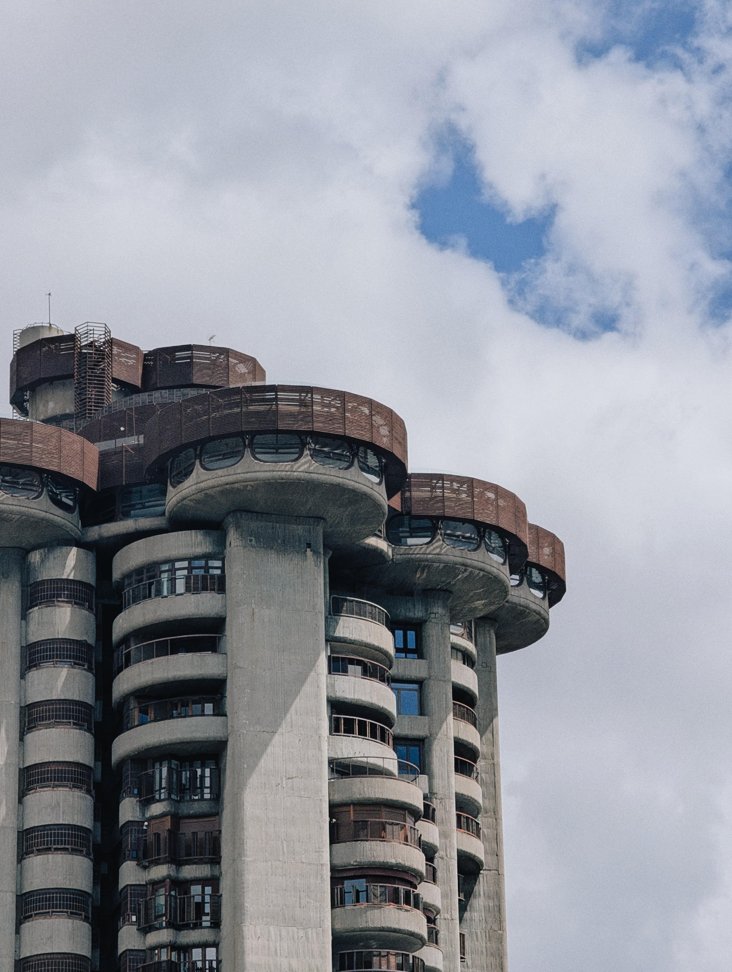 This brutalist building was designed by architect Francisco Javier Sáenz de Oiza and built between 1964 and 1969. It is one of the most extraordinary and eccentric examples of 20th-century Spanish architecture. The form is reminiscent of a giant, organic tree, with cantilevered, mushroom-shaped balconies stacking upward. Despite its massive concrete character, it has an almost futuristic, sculptural presence.
